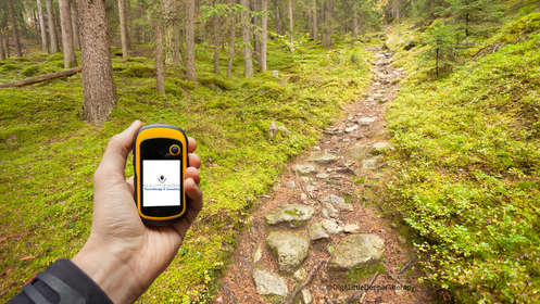 When Your Partner Resists Therapy: Understanding Barriers & Taking Healing Steps 1 Image of a man on a hike holding out a compass